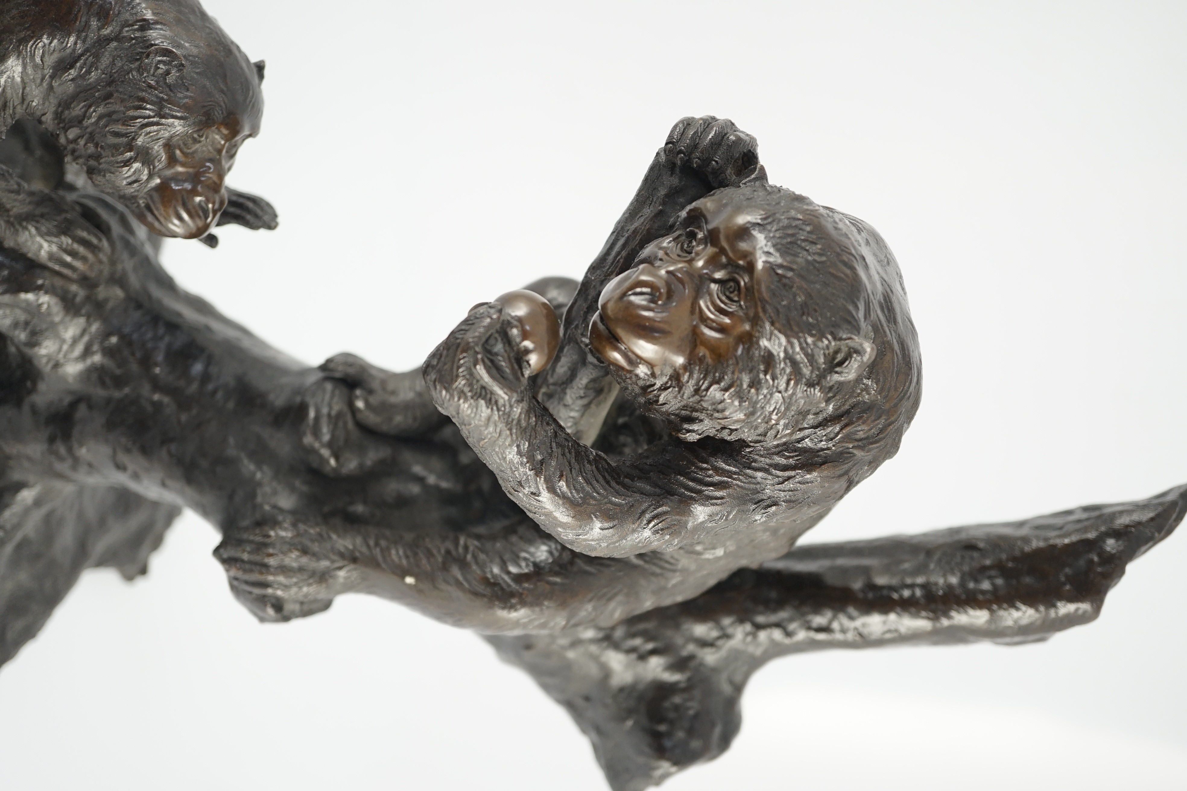 A large Japanese bronze group of two monkeys on a tree, by Genryusai Seiya, Meiji period, 42.5cm high, 43cm wide